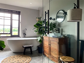 Bathroom remodel with freestanding tub and wood vanity