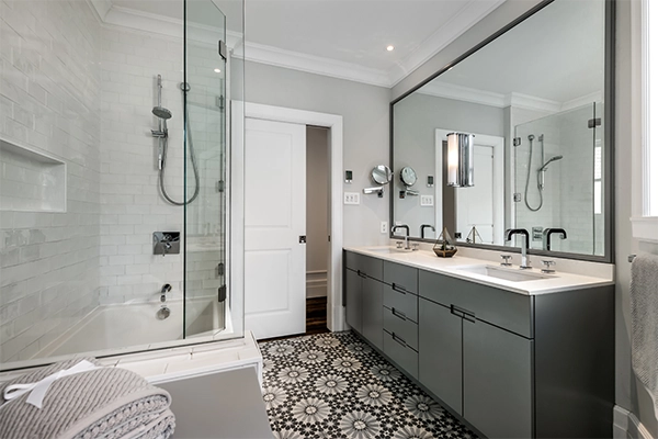 Bathroom Remodel with Double Vanity and Modern Fixtures Modern double vanity bathroom remodel with glass tub enclosure and patterned tile floors
