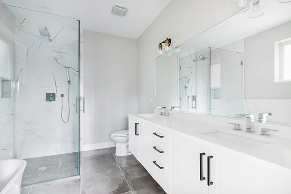 Modern bathroom remodel with white double vanity and walk-in shower