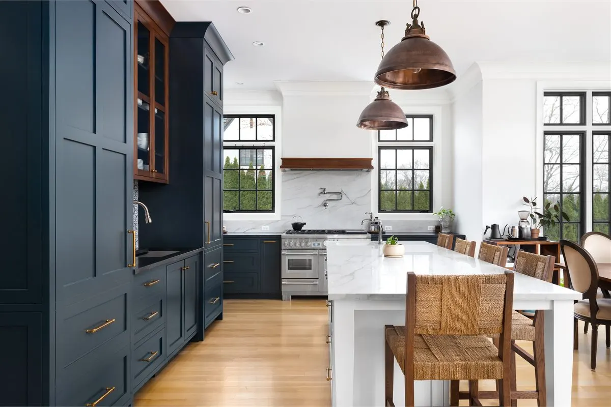 Custom kitchen cabinets and storage with white shaker cabinetry and quartz island