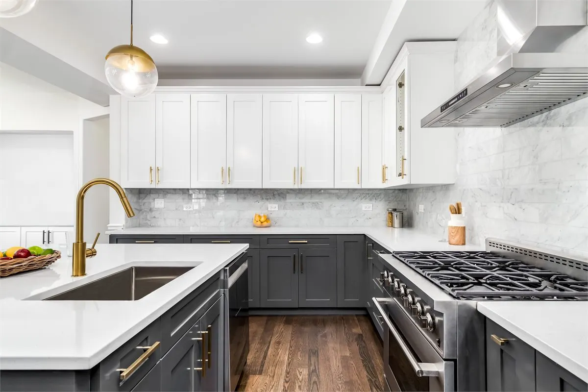 Quartz countertops and tile backsplash in modern kitchen remodel